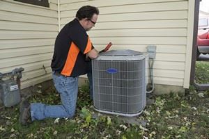 man fixing condenser