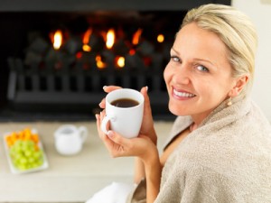 Woman smiling while holding a mug