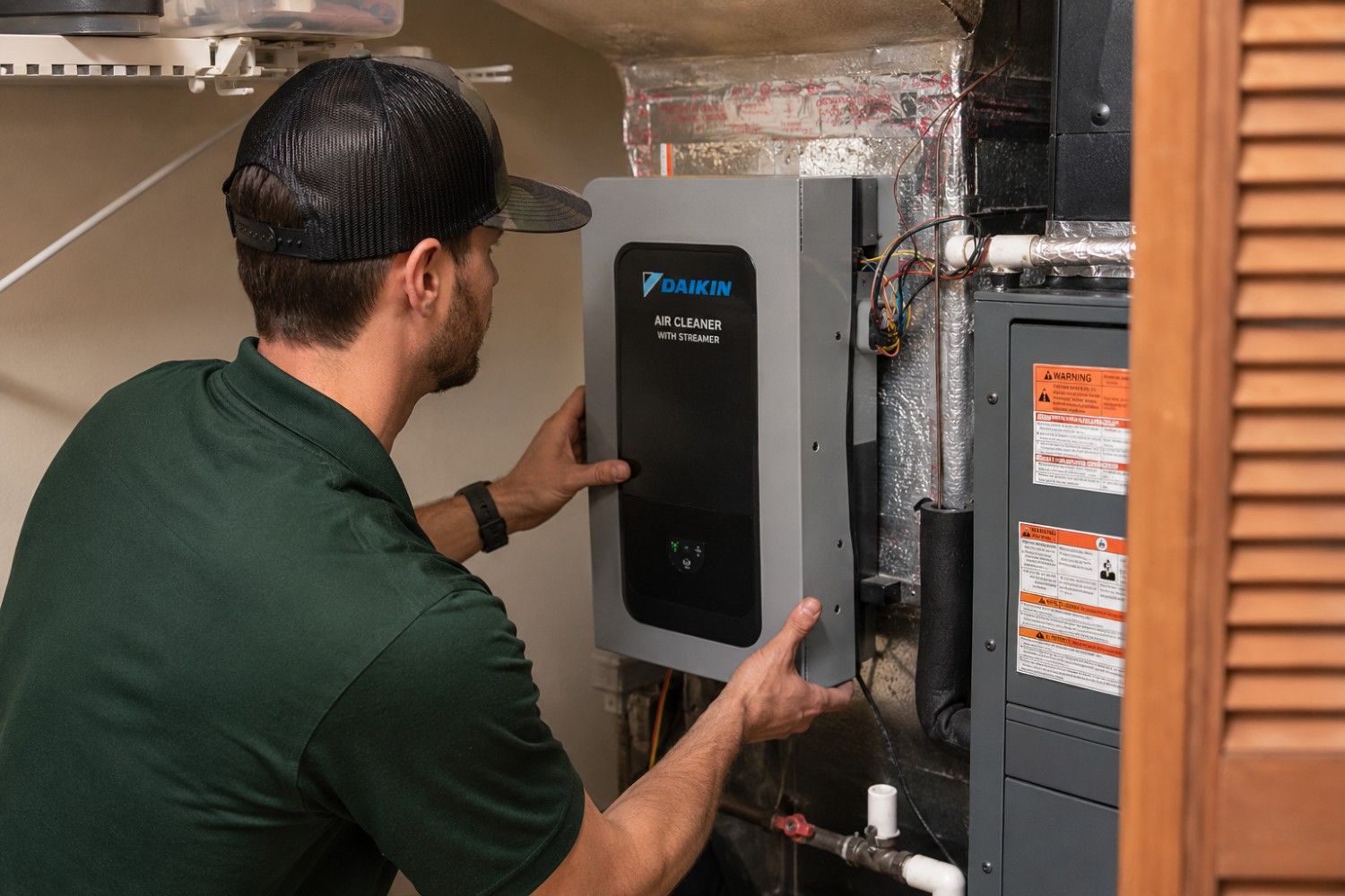 Forest Air technician installing a whole-home air cleaner on an indoor HVAC system in St. Petersburg, FL