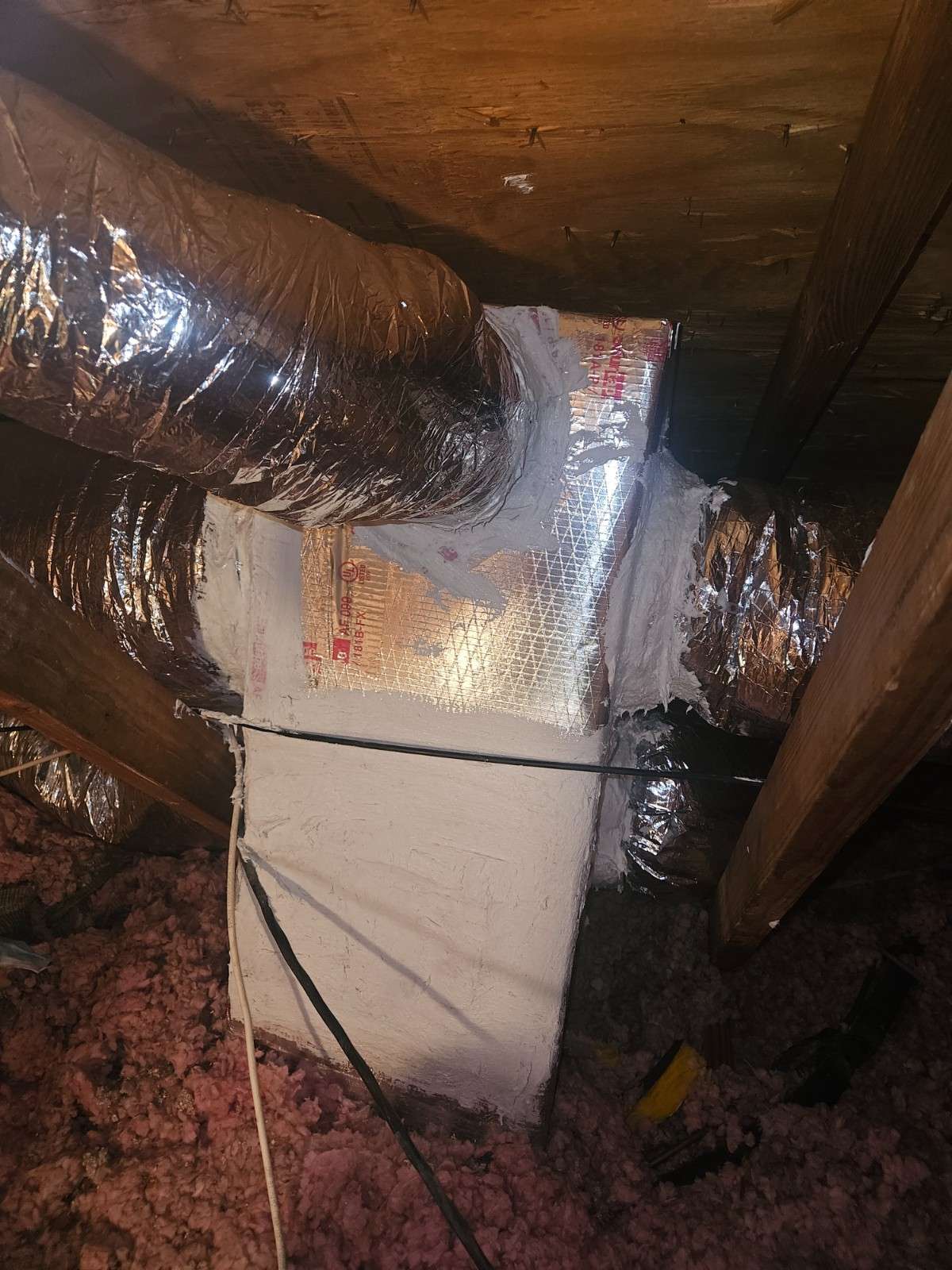 Insulated ductwork connected to an air handler in a crawlspace