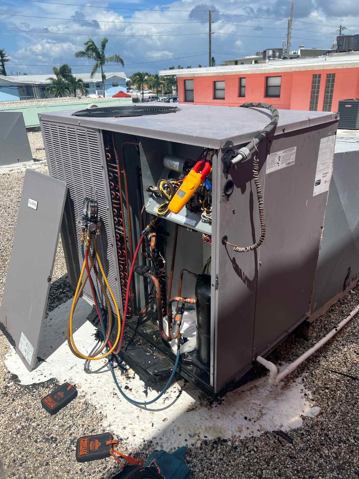 Open access panel on a commercial rooftop unit during an HVAC repair