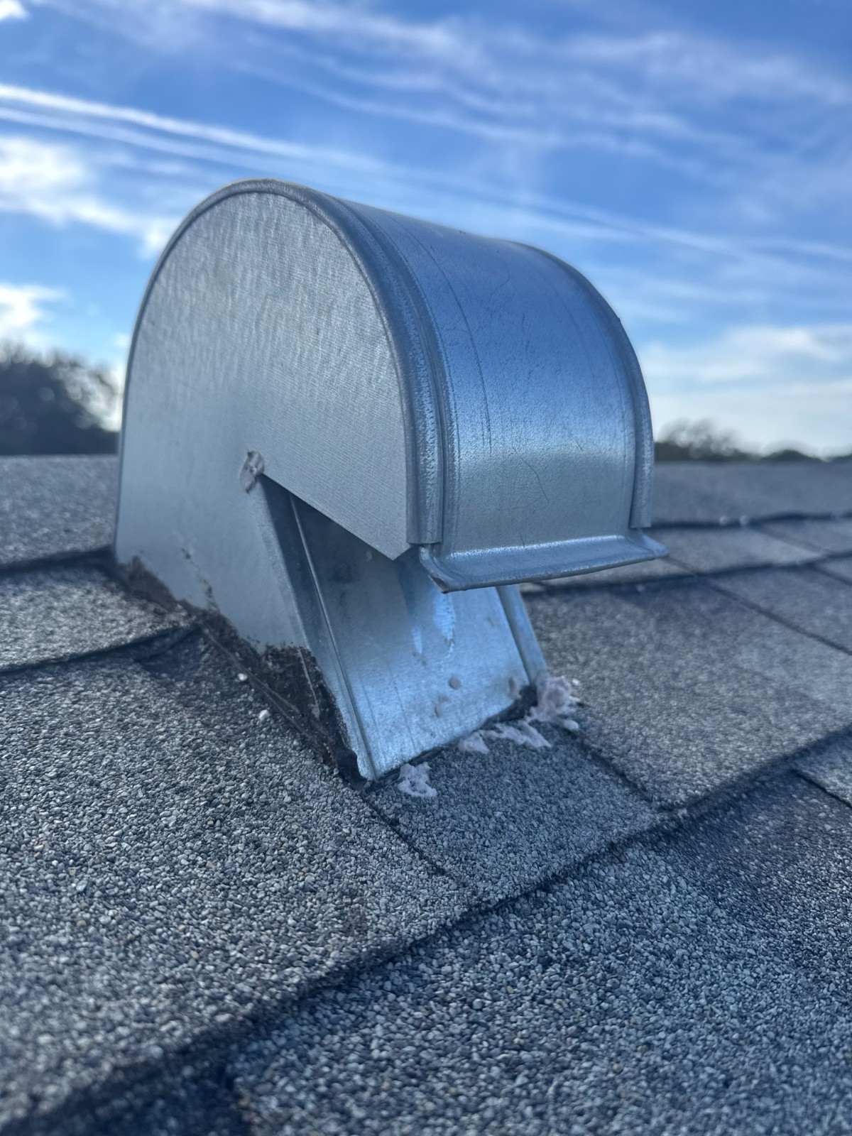 Dryer vent exhaust cap on a home's roof