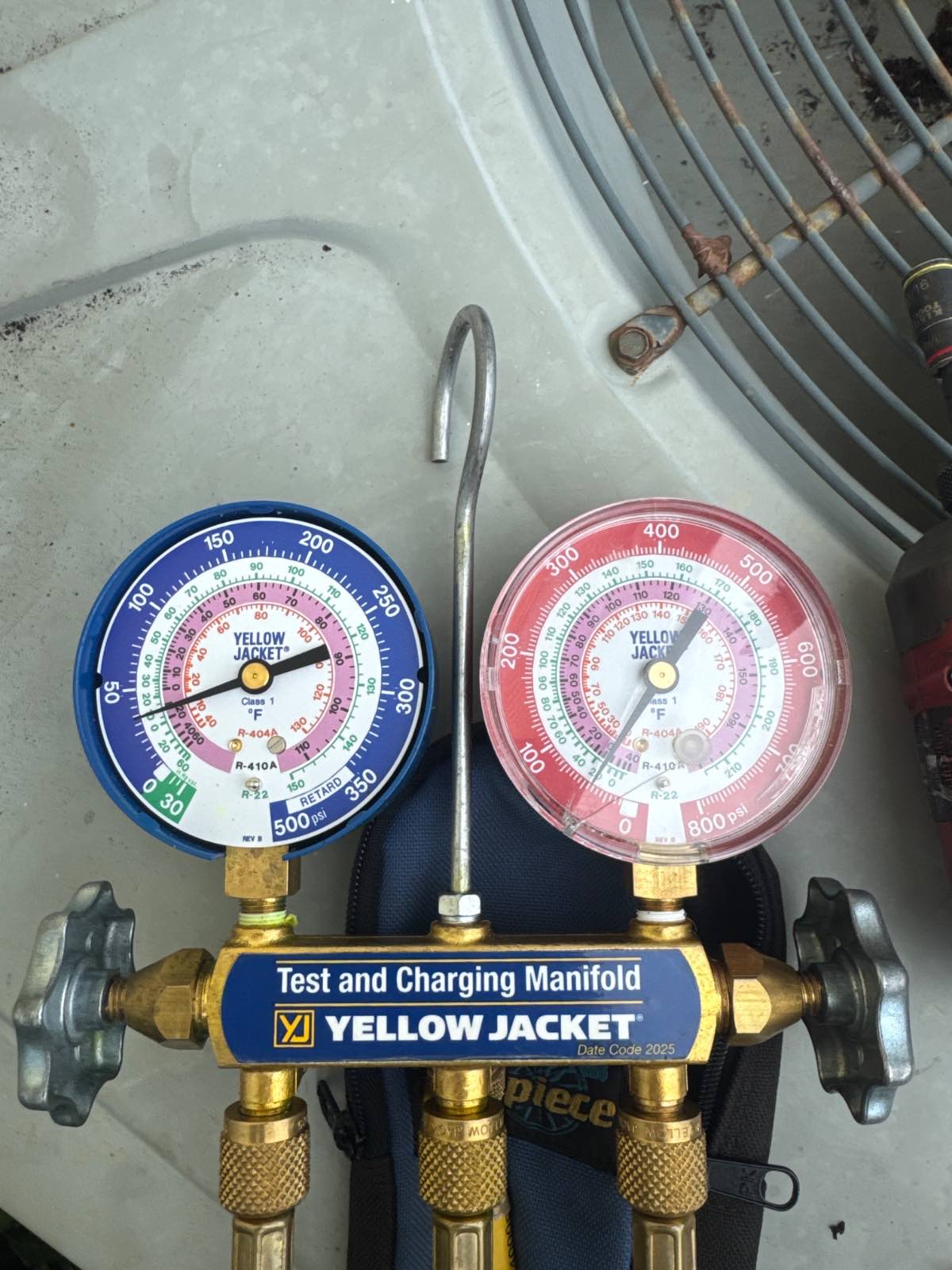 Refrigerant gauges connected to a heat pump during a heat pump repair