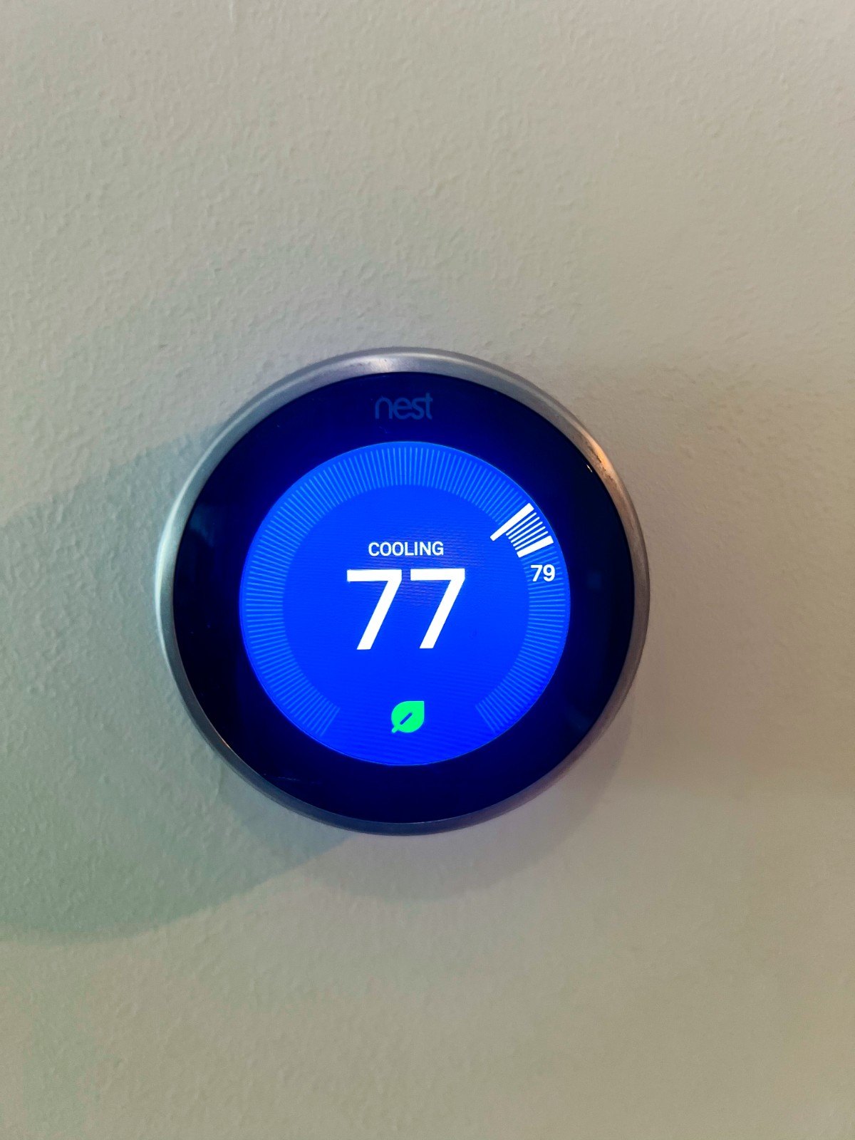 Smart thermostat set to 77°F after a thermostat installation in a Pinellas County, FL home