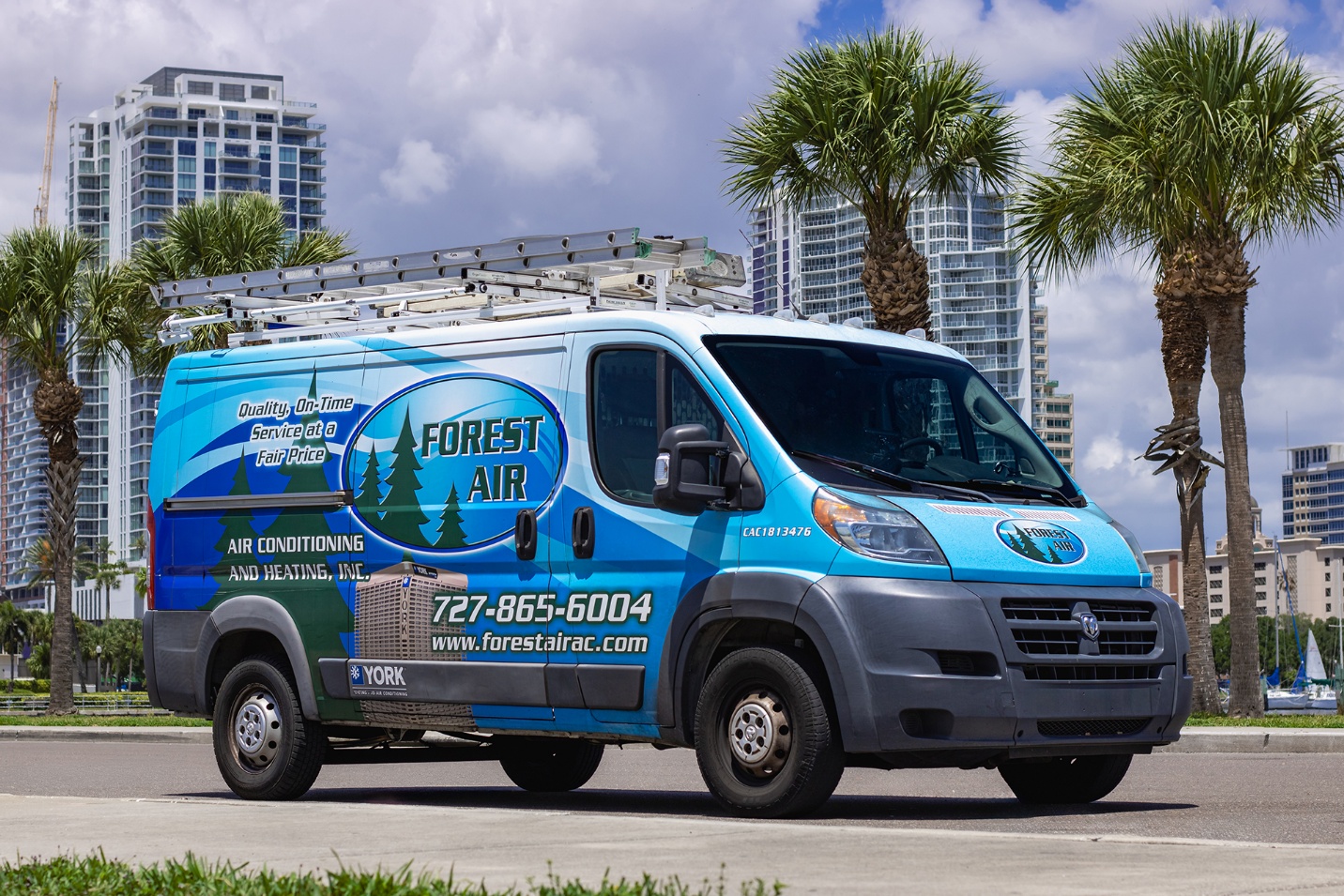 Forest Air service van parked beside palm trees in downtown St. Petersburg, FL