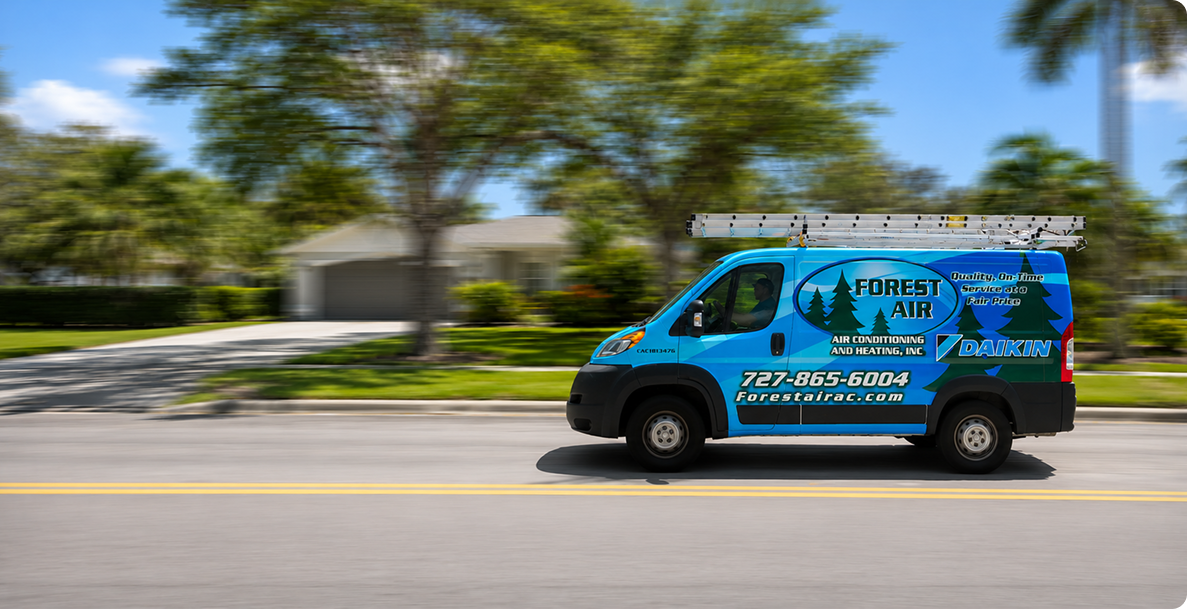 Forest Air service van driving through a palm-lined Pinellas County, FL neighborhood