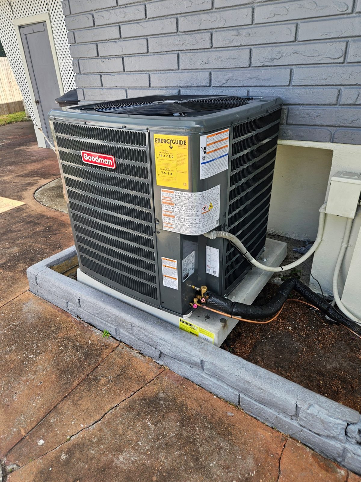 New Goodman air conditioner condenser installed by Forest Air beside a Pinellas County home
