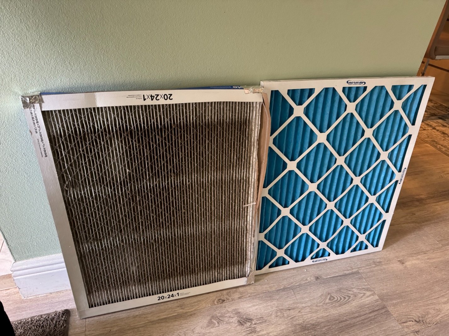 Dirty HVAC air filter beside a clean replacement filter in a Clearwater, FL home