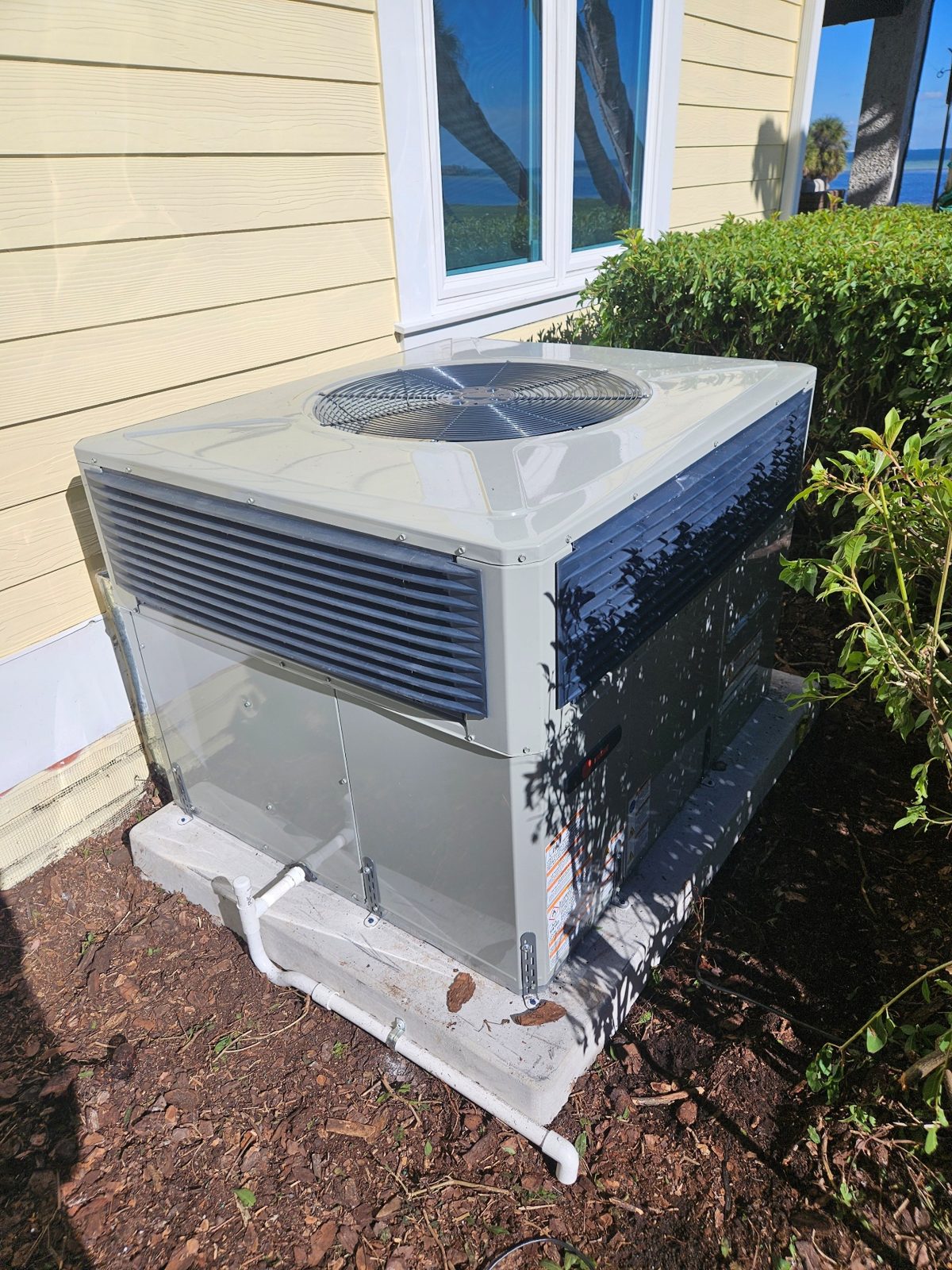Heat pump outdoor unit serviced by Forest Air beside a Pinellas County home